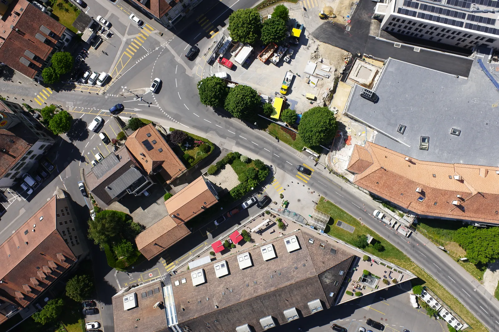 One frame from the flight, looking straight down on a town crossroads, roofs and trees.