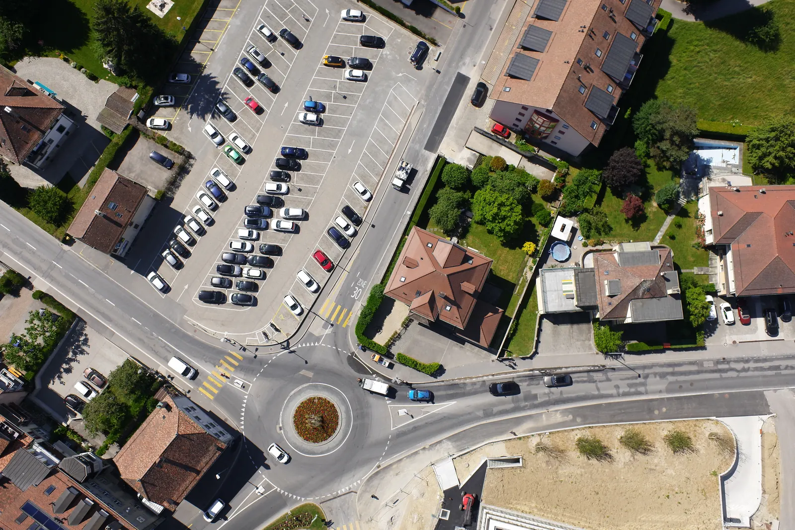 A third overlapping frame from the same flight, over a car park and houses.